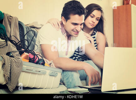 Happy couple preparing for honeymoon and making planning list Stock Photo