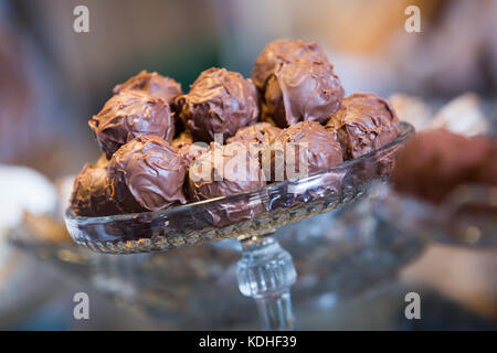 Delicious confectionary covered with milky chocolate icing at cafe display Stock Photo