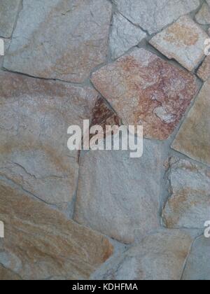 Wall lined with decorative beige stone closeup Stock Photo