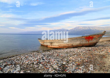 Wooden fishing boats moored on the beach of Lake Ohrid in Pogradec, Albania Stock Photo