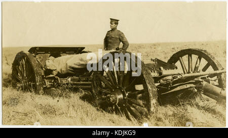 Soldier Standing Next to Artillery Gun Stock Photo