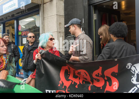 London, UK. 14th October 2017. Class War asks two people leaving the so-called 'museum' in Cable St  if they enjoyed seeing exhibits glorifying the brutal series of 19th century murders and exhibiting materials relating to the death of working class women. Credit: Peter Marshall/Alamy Live News Stock Photo