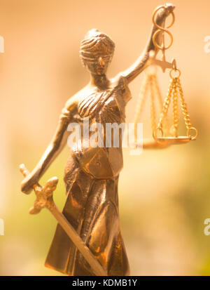 Legal law firm bronze statue of the goddess themis with scales of justice in attorneys office. Stock Photo