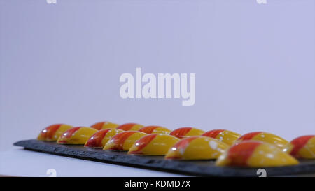 shiny caramel candies. Caramel candies. Row of color caramel candies isolated on a white background. Stock Photo