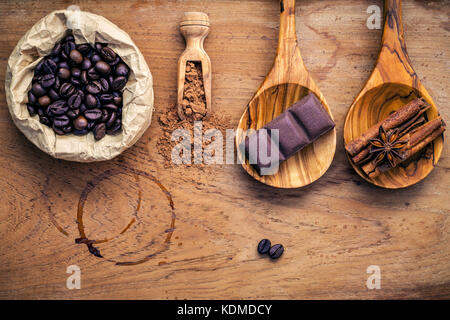 Coffee background and menu design. Ingredients for latte coffee . Roasted coffee beans in paper bag  ,chocolate bar ,chocolate powder ,star anise and  Stock Photo