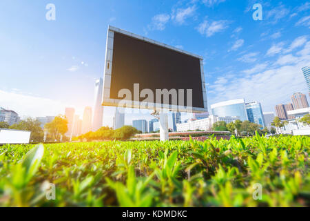 Big white blank billboard in modern city over blue sky background. Stock Photo
