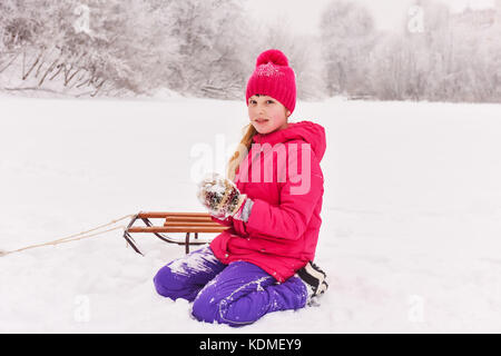 girl enjoying day playing in winter forest Stock Photo