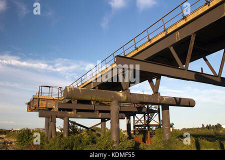 Disused Jetty at Holehaven Creek, Canvey Island, Essex, England, against a blue sky Stock Photo