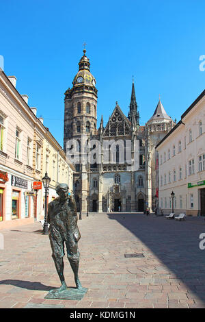 KOSICE, SLOVAKIA - AUGUST 29, 2015: Statue of painter Julius Jakoby and St. Elizabeth Cathedral in the heart of Kosice Stock Photo