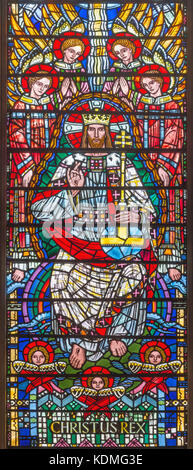 Stained glass of Lord Jesus Christ as the King of Heaven sat upon his ...