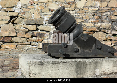 cannon mortar near the stone wall in the fortress Stock Photo