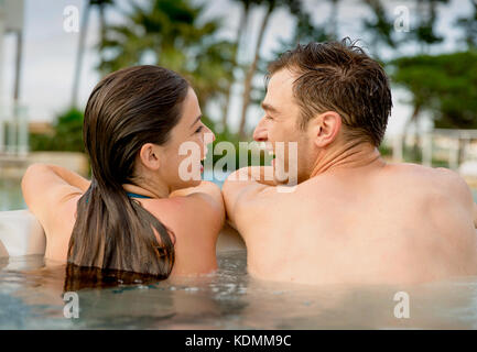 Young couple in a luxury hotel inside a jacuzzi enjoying the holidays Stock Photo