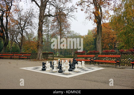 park with chess figures autumn season Stock Photo