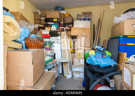 Moving, things packed in boxes and packages lie in a small room Stock Photo