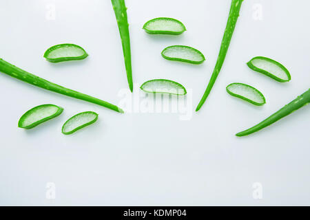 Aloe vera fresh leaves with slices aloe vera gel on wooden spoon. isolated over white Stock Photo