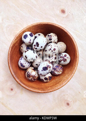 Quail eggs in wooden bowl Stock Photo