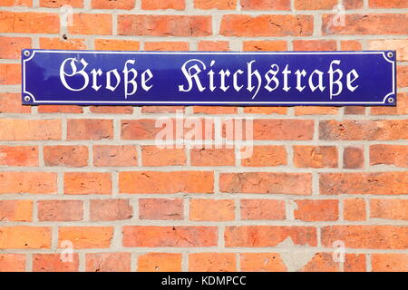 blue street sign at red brick wall, Nienburg/Weser, Lower-Saxony, Germany, Europe  I Blaues Straßenschild Große Kirchstraße auf einer Backsteinmauer,  Stock Photo