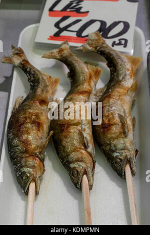 Kyoto, Japan -  May 22, 2017: Baked fishes on a stick as a snack at the Nishiki market in kyoto Stock Photo