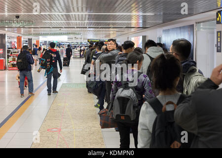 People waiting to go through passport control at Australian border in Melbourne airport Stock Photo