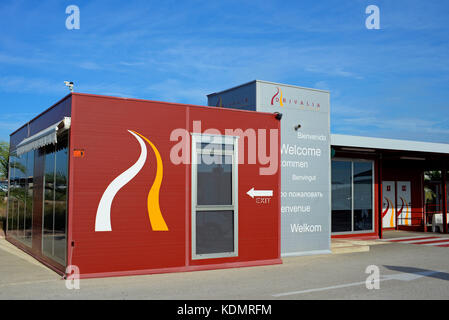 Drivalia car hire office at Alicante Airport Spain. Vehicle hire. Welcome in various languages. Customer toilets. Waiting area. Blue sky Stock Photo