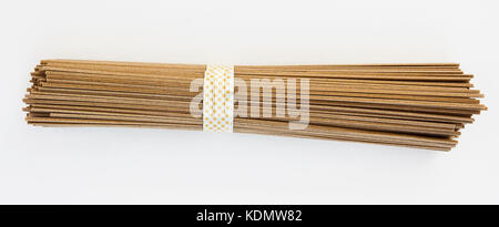 Bundle of uncooked buckwheat soba noodles. Isolated. Stock Photo