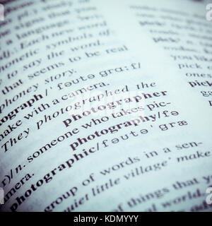 Close up of old English dictionary page with word Photographer. Shallow depth of field and toned page of word Photographer on English dictionary . Stock Photo