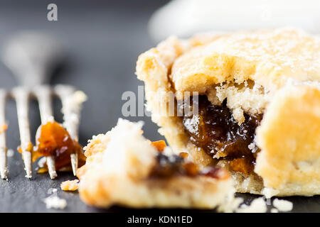 Traditional British Christmas Pastry Dessert Home Baked Mince Pie with Apple Raisins Nuts Filling. Open with Visible Texture. Golden Shortcrust Fork.  Stock Photo