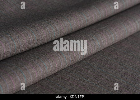 Folds of gray woolen cloth in a dark key. Stock Photo