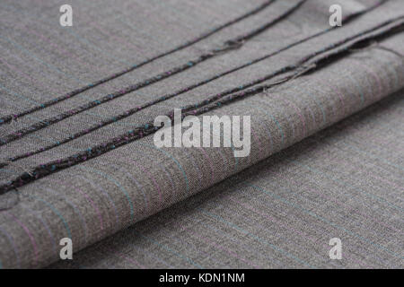 Folds of gray woolen fabric in light colors. Stock Photo