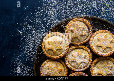 Traditional British Christmas Pastry Dessert Home Baked Mince Pies with Apple Raisins Nuts Filling Golden Shortcrust Powdered on Vintage Metal Plate D Stock Photo
