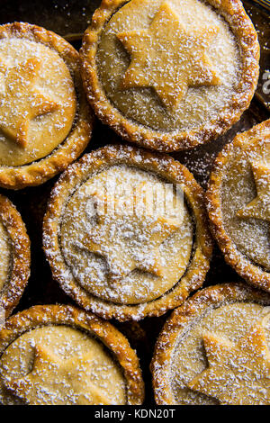 Traditional British Christmas Pastry Dessert Home Baked Mince Pies with Apple Raisins Nuts Filling Golden Shortcrust Powdered Pattern Top View Festive Stock Photo
