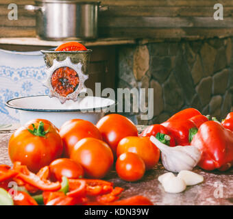 Manual vintage meat grinder and ripe tomatoes on the table. Making homemade  tomato sauce. Use of outdated kitchen utensils Stock Photo - Alamy