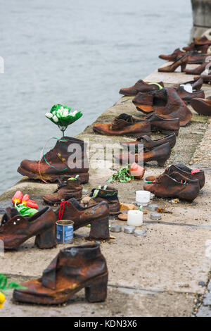 Holocaust Memorial Budapest, a collection of empty shoes alongside the River Danube signifying the city's victims of genocide in the Second World War. Stock Photo