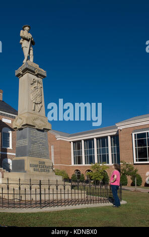 Senior Woman views Confederate memorial statue at Lancaster, South Carolina, USA. Stock Photo