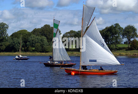 Three classic yachts, including 'Leila' (3) and 'Deilginis' (11) moored with crews preparing to race in regatta on Lough Erne, Co. Fermanagh in 2010 Stock Photo