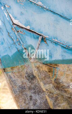 Wodden texture with old blue paint on abandoned fishing boat Stock Photo