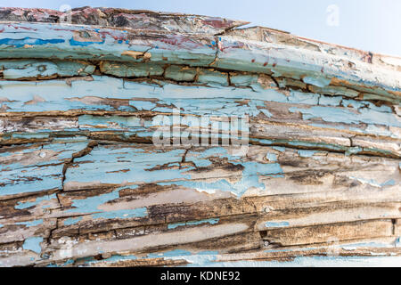 Wodden texture with old blue paint on abandoned fishing boat Stock Photo