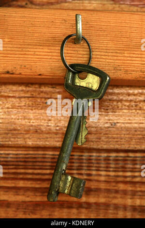 Door keys hanging on the wooden wall Stock Photo