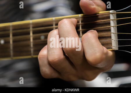 acoustic / steel-string guitar close-up playing chord for rock and folk music Stock Photo