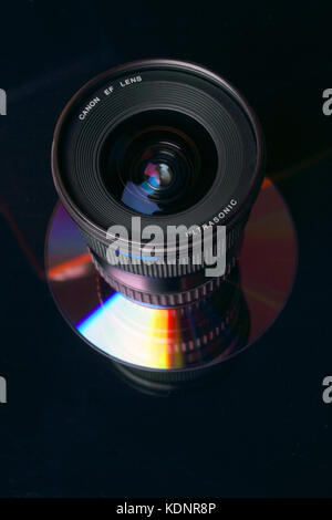 Canon EF 17-35 mm lens reflected on DVD. Stock Photo