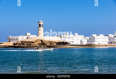 Sur Lighthouse with fisherman boat - Sur, Oman Stock Photo