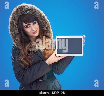 Portrait of a beautiful brunette woman holding an empty tablet Stock Photo