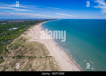 Italy, the beach of the Adriatic sea. Rest on the sea near Venice. Aerial FPV drone photography. Stock Photo