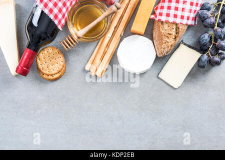 Healthy brunch with red wine,cheese,grapes and honey. Stock Photo