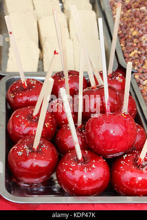 Traditional fair treats glazed apples on a stick Stock Photo