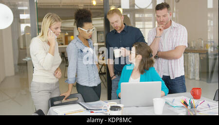 Coworkers watching laptop Stock Photo