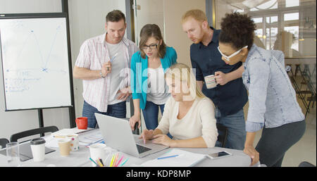 People in office watching laptop Stock Photo