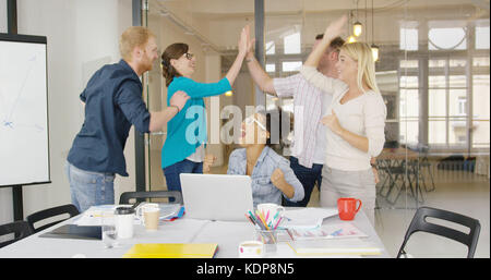 Workers giving high five Stock Photo