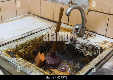 old clogged a sink in the rust, the old kitchen, clogged sink Stock Photo