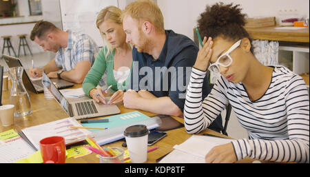Young people working hard in office Stock Photo